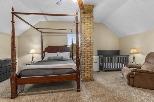 1 dormitorio con cama con dosel y sofá en Charming 4BR Westside Home in Beer City USA, en Grand Rapids