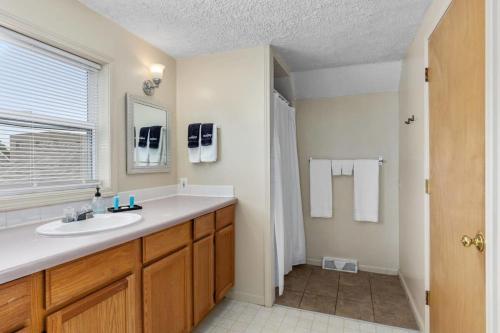 a bathroom with a sink and a shower at Charming 4BR Westside Home in Beer City USA in Grand Rapids
