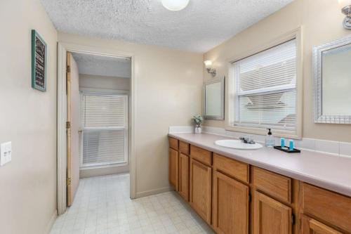 a bathroom with a sink and a mirror at Charming 4BR Westside Home in Beer City USA in Grand Rapids