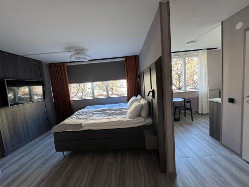 a bedroom with a bed with a large window at City Central Hotel Örebro by First Hotels in Örebro