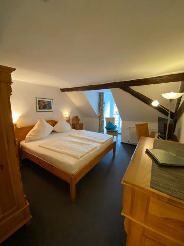 a bedroom with a large bed in a room at Hotel Hieronimi in Cochem