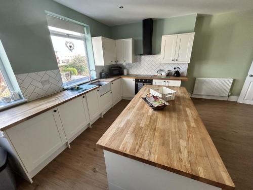 a kitchen with a wooden counter top in a room at Sandy Lodge in Hornsea