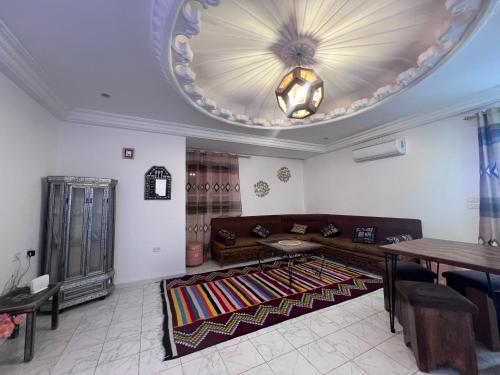 a living room with a couch and a table at Dar Beya ( APP S+2 ) in Tozeur