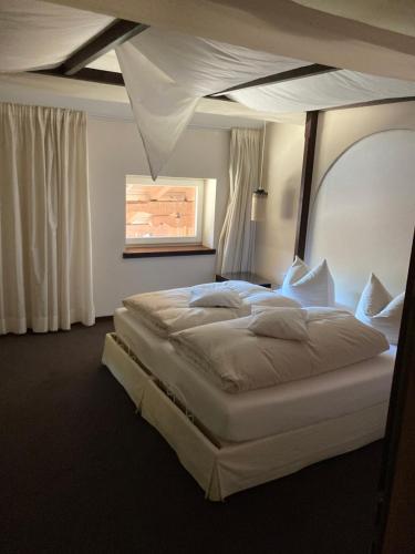 a bedroom with a large bed in a room at Alpenhof in Bayrischzell