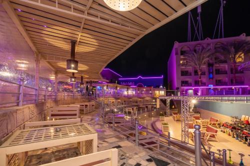 a view of a restaurant with purple lighting at El Karma Beach Resort & Aqua Park - Hurghada in Hurghada