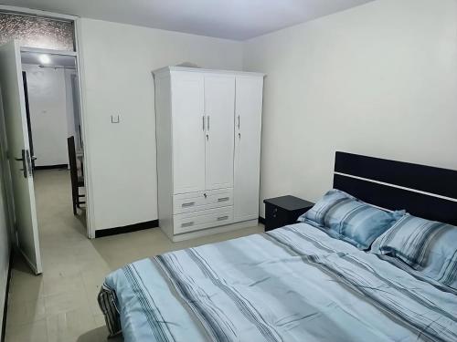 a bedroom with a large bed and a closet at FevKoti in Addis Ababa
