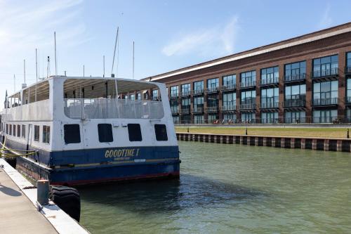a boat is docked in the water in front of a building at Marlin at the Lake - Downtown Sandusky in Sandusky