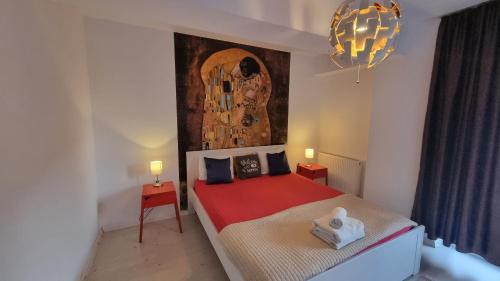 a bedroom with a bed with a painting on the wall at Airport Residence in Otopeni