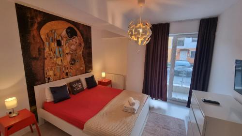 a bedroom with a bed with a large painting on the wall at Airport Residence in Otopeni