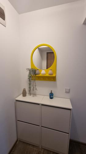 a bathroom with a mirror and a white sink at Airport Residence in Otopeni