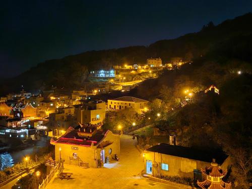 a view of a town at night with lights at Lohas Seaview B&B in Beigan
