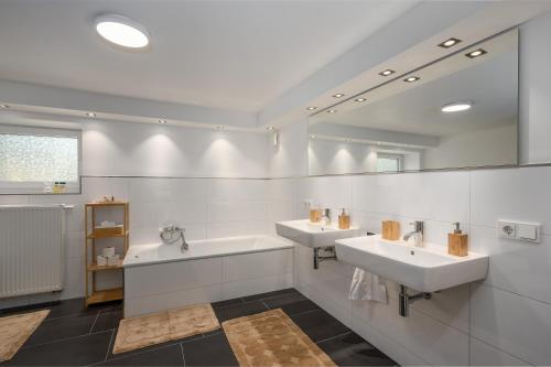 La salle de bains est pourvue de 2 lavabos et d'un miroir. dans l'établissement Entspannung im Boho-Flair: Sauna & Whirlpool, à Schwerte