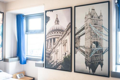 three framed photographs of the tower of london on a wall at St Christopher's Inn Shepherd's Bush in London