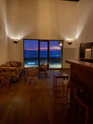 a living room with a couch and a large window at Spice of Ceylon in Chilaw