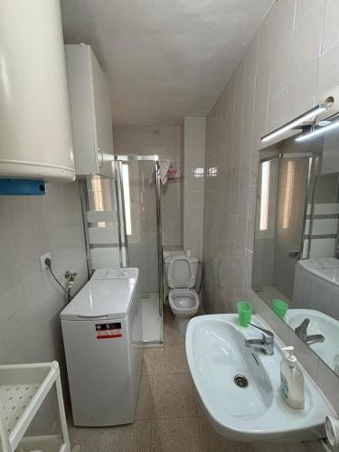 a bathroom with a sink and a toilet at ESTUDIO DOS PLAYAS LA MANGA in Murcia