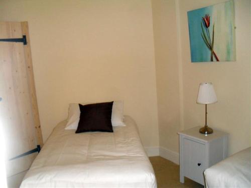 a bedroom with a bed with a pillow on it at Otters Holt at Tove Valley Cottages in Towcester