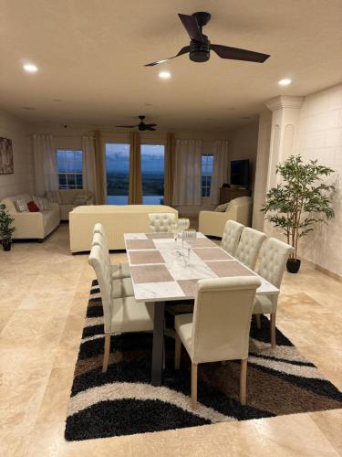 a dining table and chairs in a living room at Amaro Villas Barbados Feel like when you're home in Saint Thomas