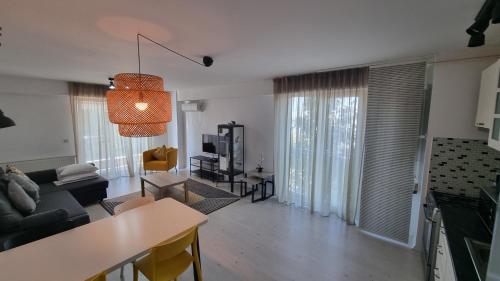 a living room with a couch and a table at Airport Residence in Otopeni