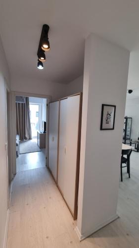 an empty room with a hallway with white walls at Airport Residence in Otopeni
