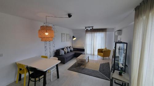 a living room with a couch and a table at Airport Residence in Otopeni