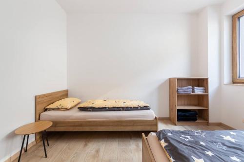 a small bedroom with a bed and a table at Duplex Holiday Apartment in Škofljica