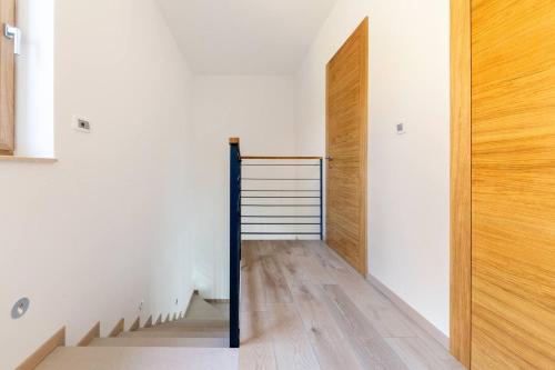 a hallway with a wooden door and a staircase at Duplex Holiday Apartment in Škofljica