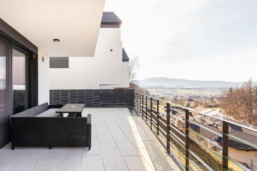 a balcony with a bench and a lighthouse at Duplex Holiday Apartment in Škofljica