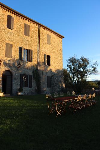 a table and chairs in front of a building at Castello di Viano in Viano