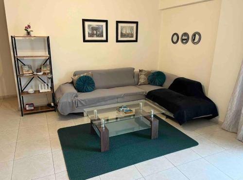 sala de estar con sofá y mesa de cristal en Bright One Bedroom Apartment in Paphos area en Pafos