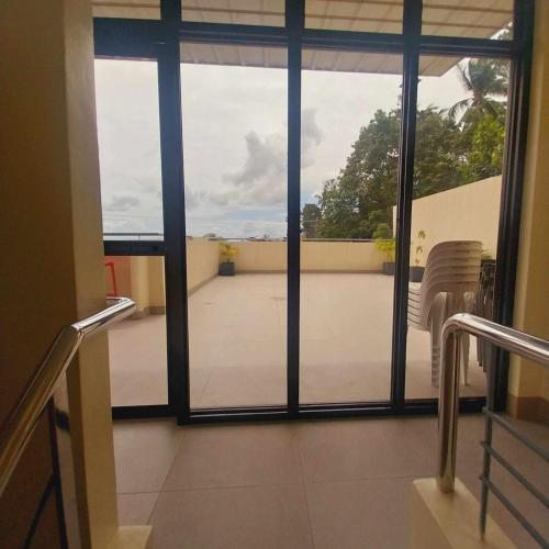 a room with a view of a balcony with a window at Eli's Villa Cebu in Cebu City