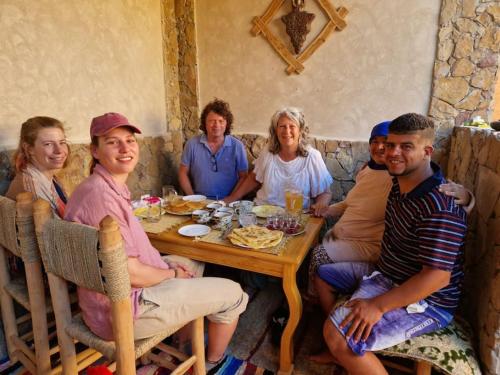 a group of people sitting around a table at Authentic Moroccan Family Homestay in Tabaïat