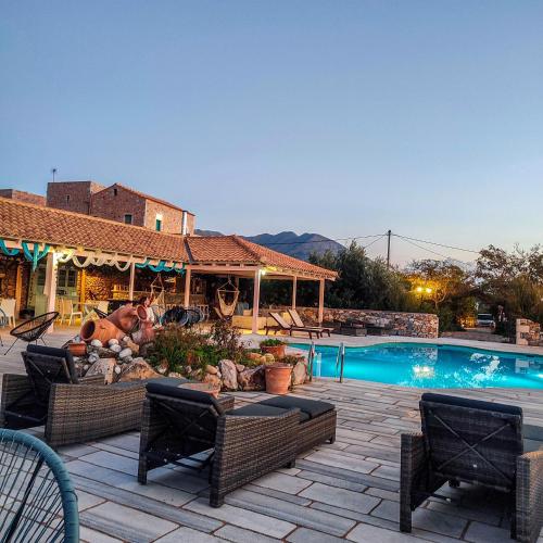 a backyard with a swimming pool and a house at Ktima Karageorgou in Areopolis