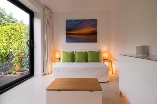 a bedroom with a bed and a large window at Lyndhurst House in Canterbury