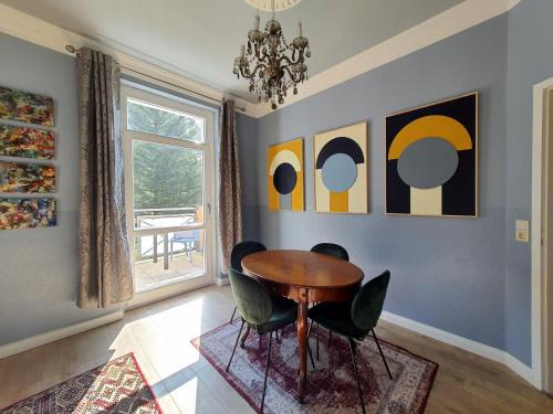 a dining room with a table and chairs at ArtHouse Am Kurpark Bad Schandau in Bad Schandau