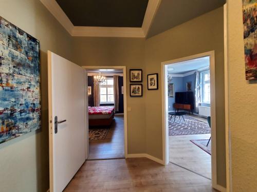 a hallway with a door leading to a living room at ArtHouse Am Kurpark Bad Schandau in Bad Schandau