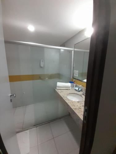 a bathroom with a sink and a mirror at Sonia Flats Pipa's Bay - Flat 211 in Pipa