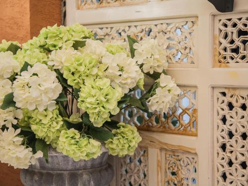 a vase filled with white flowers on a wall at Anna King Hotel in Chiayi City