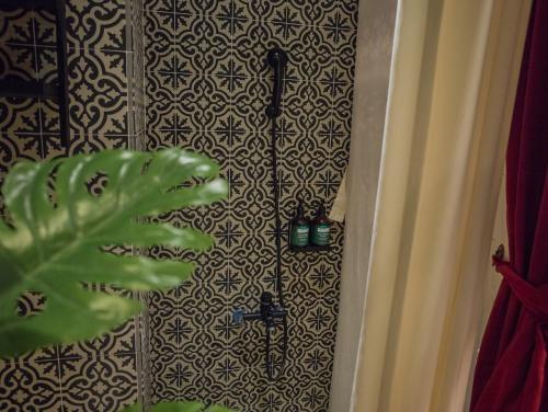 a shower in a bathroom with a black and white wall at Anna King Hotel in Chiayi City