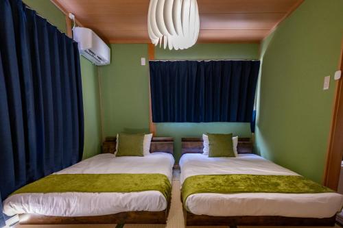 Postel nebo postele na pokoji v ubytování Satorie Beppu