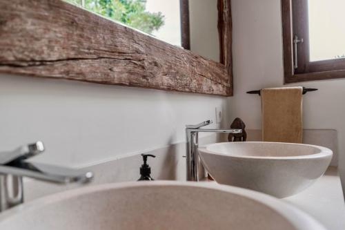 a bathroom with a white sink and a mirror at Villa Alba, Berawa Beach in Canggu