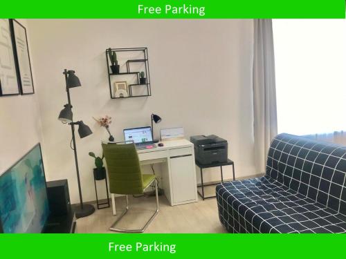a room with a desk with a computer and a couch at Apartmantplus01 in Prague