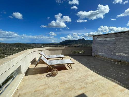a patio with a bench on top of a roof at B&b La Casa Nel Vento in Torpè