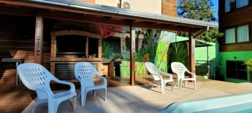 a group of chairs sitting on a patio at Hotel Los Lapachos in Puerto Iguazú