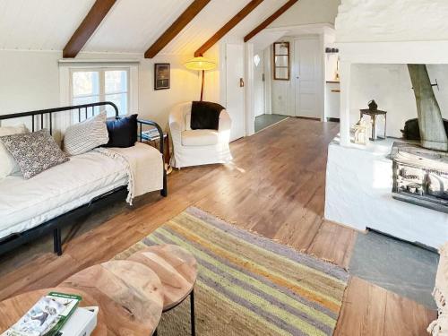a living room with a white couch and chairs at 4 person holiday home in FÄRJESTADEN-By Traum in Färjestaden