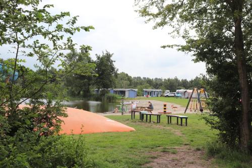 a park with a playground and a play structure at Vakantiepark de Kleine Wielen in Leeuwarden
