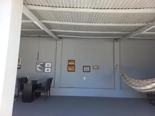 Zimmer mit Hängematte, Tisch und Stühlen in der Unterkunft Linda edícula a 80 m da Praia de Itapuã in Salvador