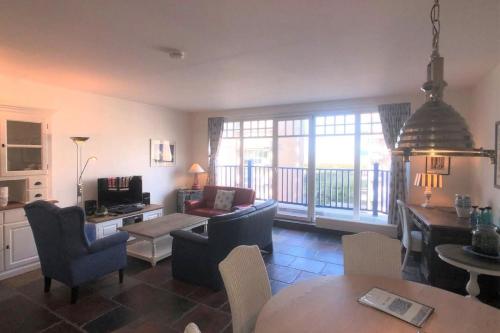 a living room with a couch and a table at Villa Duindoorn 2.302 in Cadzand