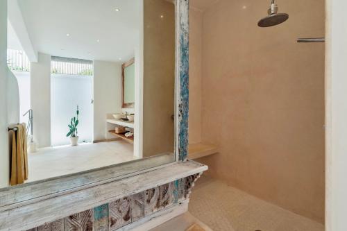 a room with a mirror on the wall at Villa Alba, Berawa Beach in Canggu