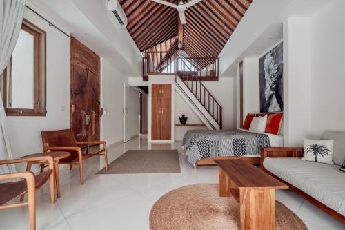 a living room with a bed and a couch at Villa Alba, Berawa Beach in Canggu