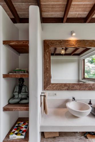 a bathroom with a sink and a mirror at Villa Alba, Berawa Beach in Canggu
